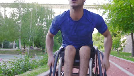 Disabled-man-climbing-ramp,-uphill-with-ambitious-wheelchair.